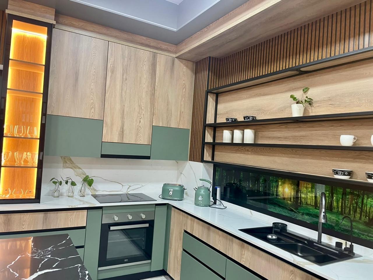 Showroom kitchen in timber and sage finishes with illuminated display cabinetry