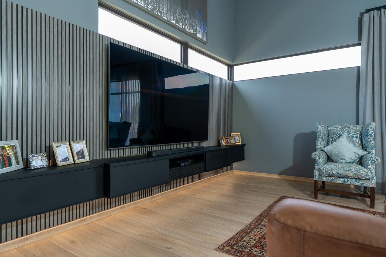 Contemporary living room media wall with dark floating cabinetry
