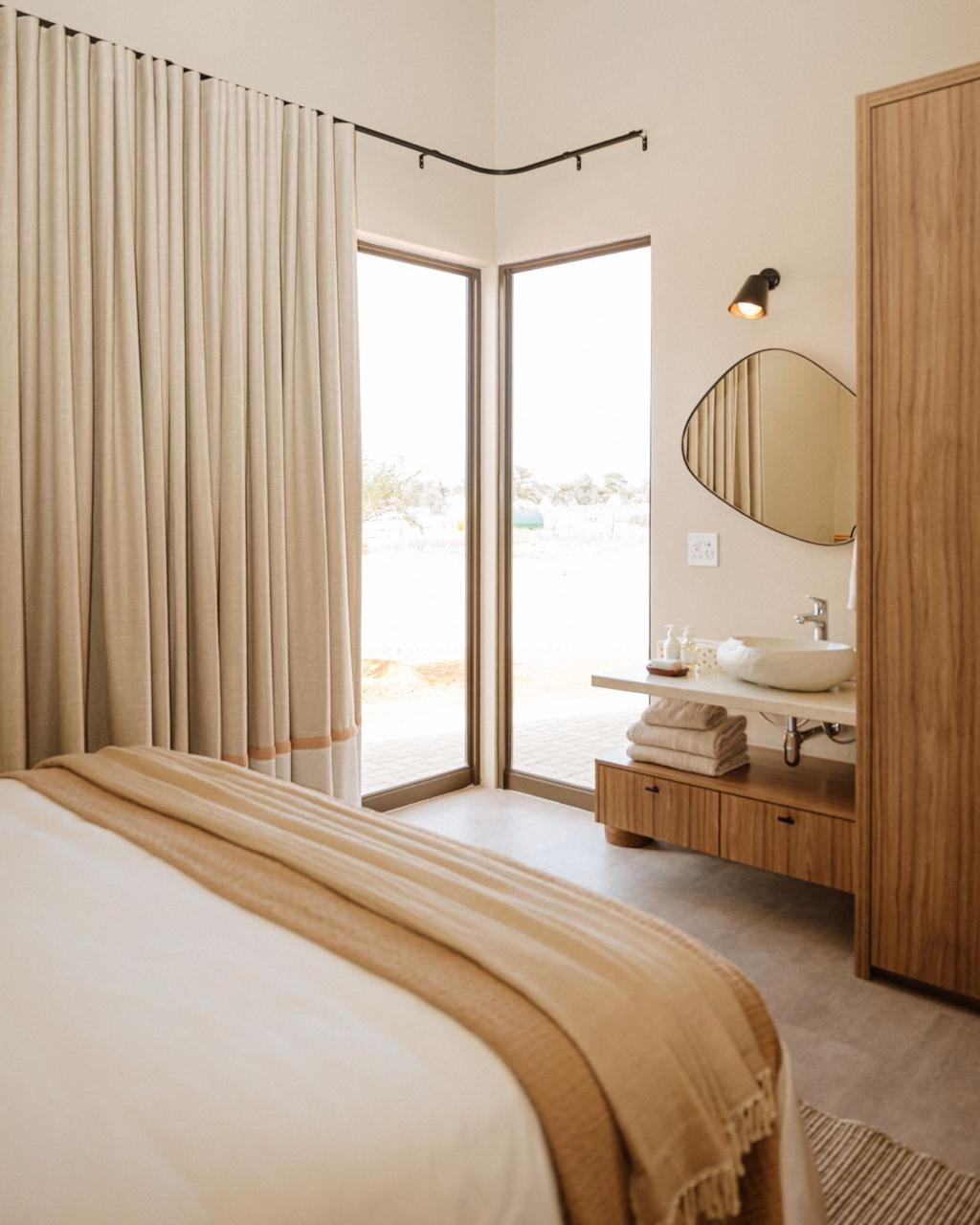 Neutral bedroom with integrated timber vanity and wardrobe