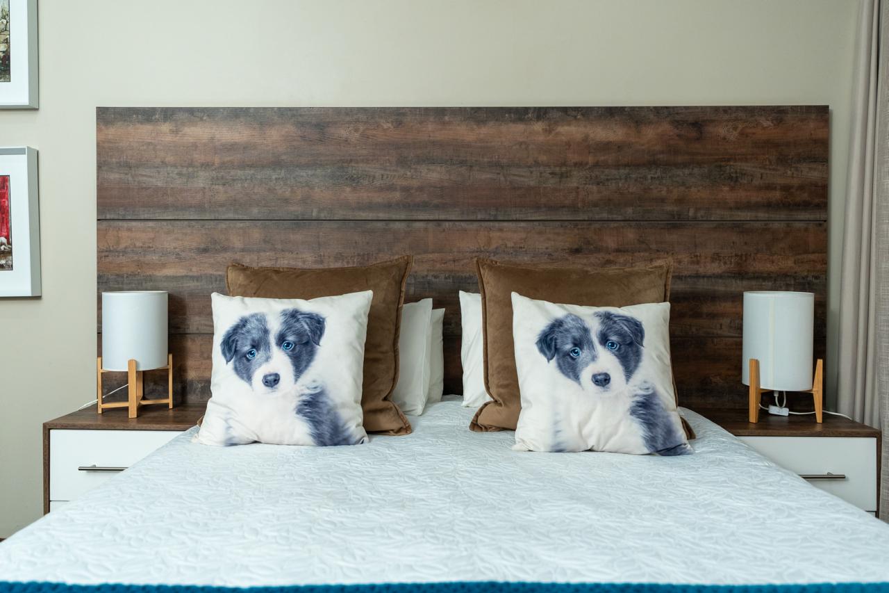 Bedroom with a rustic timber headboard and integrated bedside units